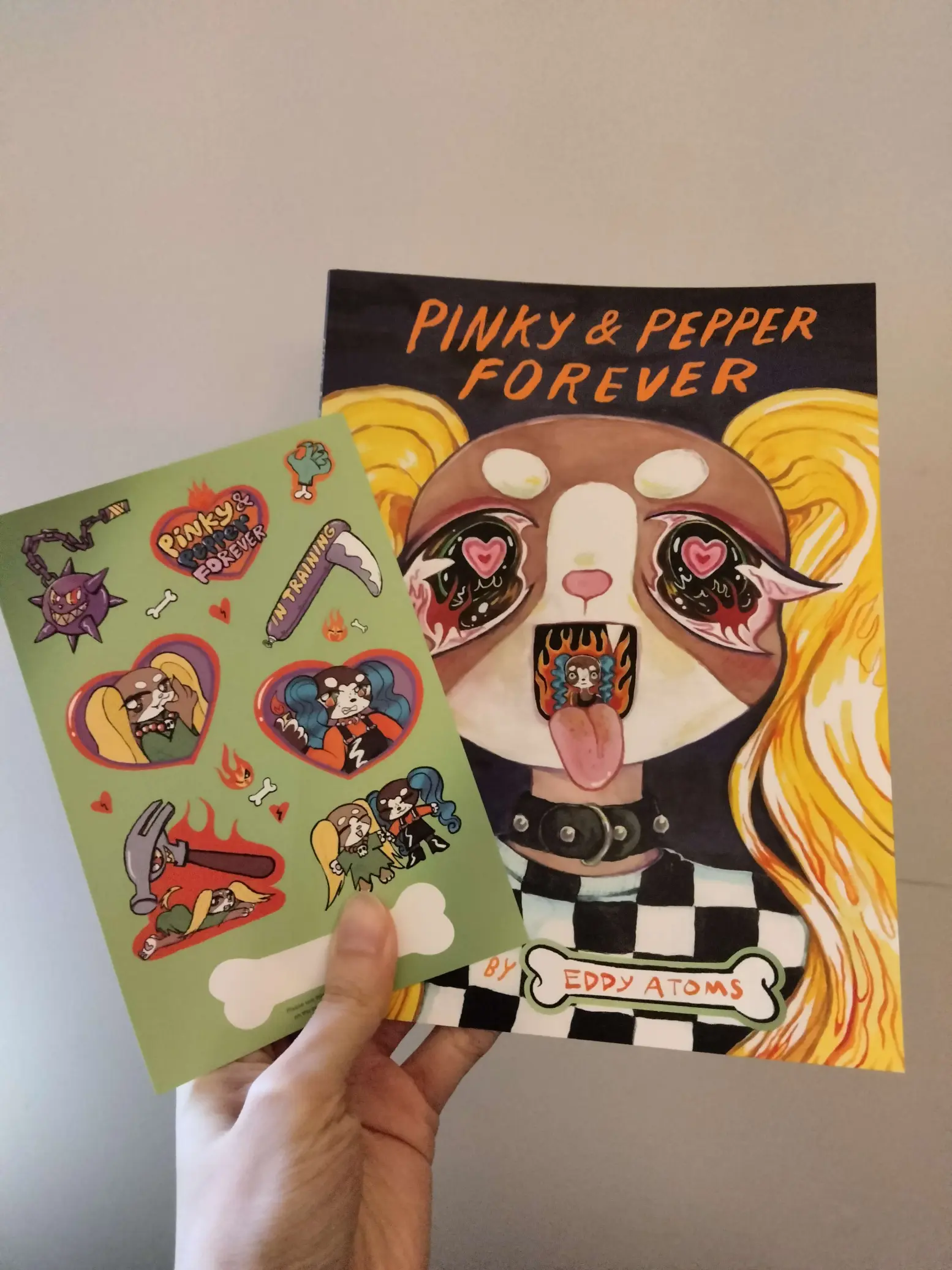 A photo of the physical comic and sticker sheet.